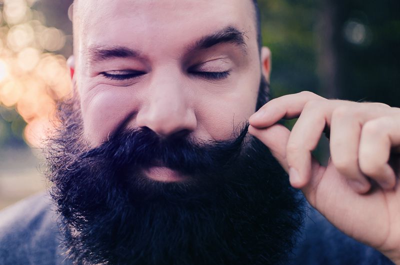 Man using moustache wax