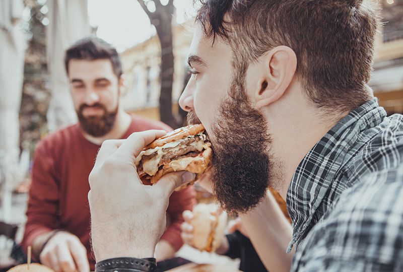 Man with beard eating